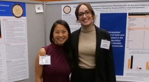 researchers in front of their poster